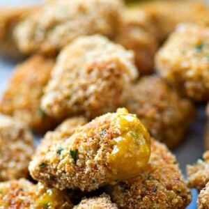 Breaded chicken nuggets with sauce.