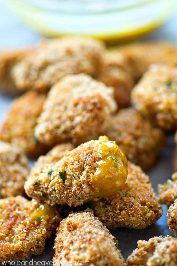 Breaded chicken nuggets with sauce.