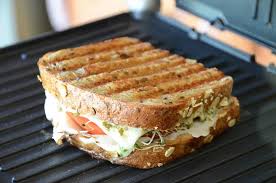 Grilled sandwich cooking on grill
