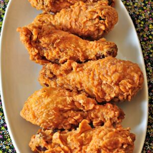 Crispy fried chicken drumsticks on plate