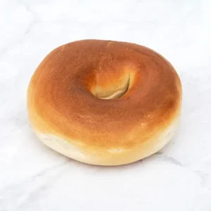 Golden brown bagel on marble.