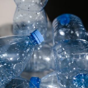 Multiple empty plastic bottles with water droplets in a close-up shot, highlighting recycling.